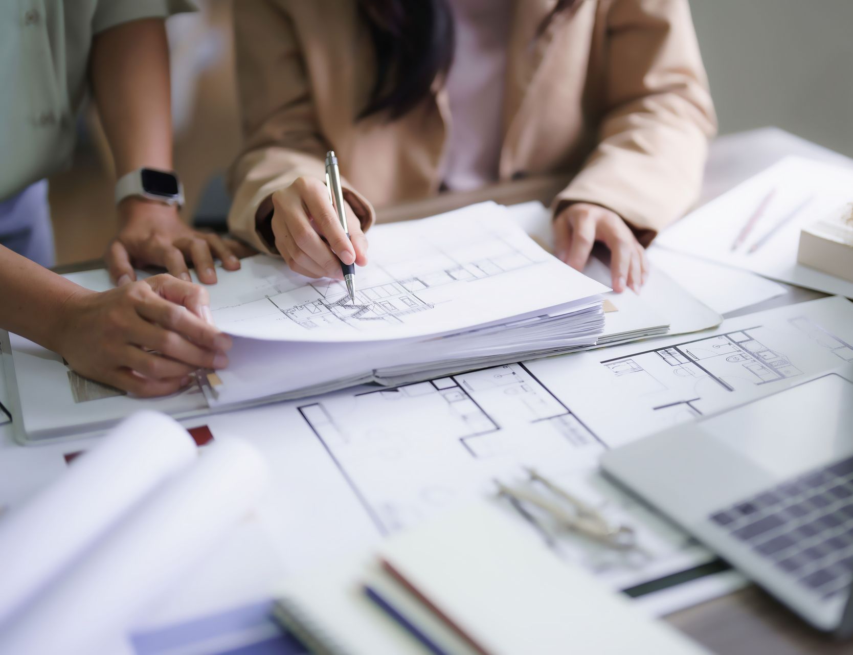 Deux femmes architectes discutent de la conception intérieure d'un projet de construction et dessinent sur un plan