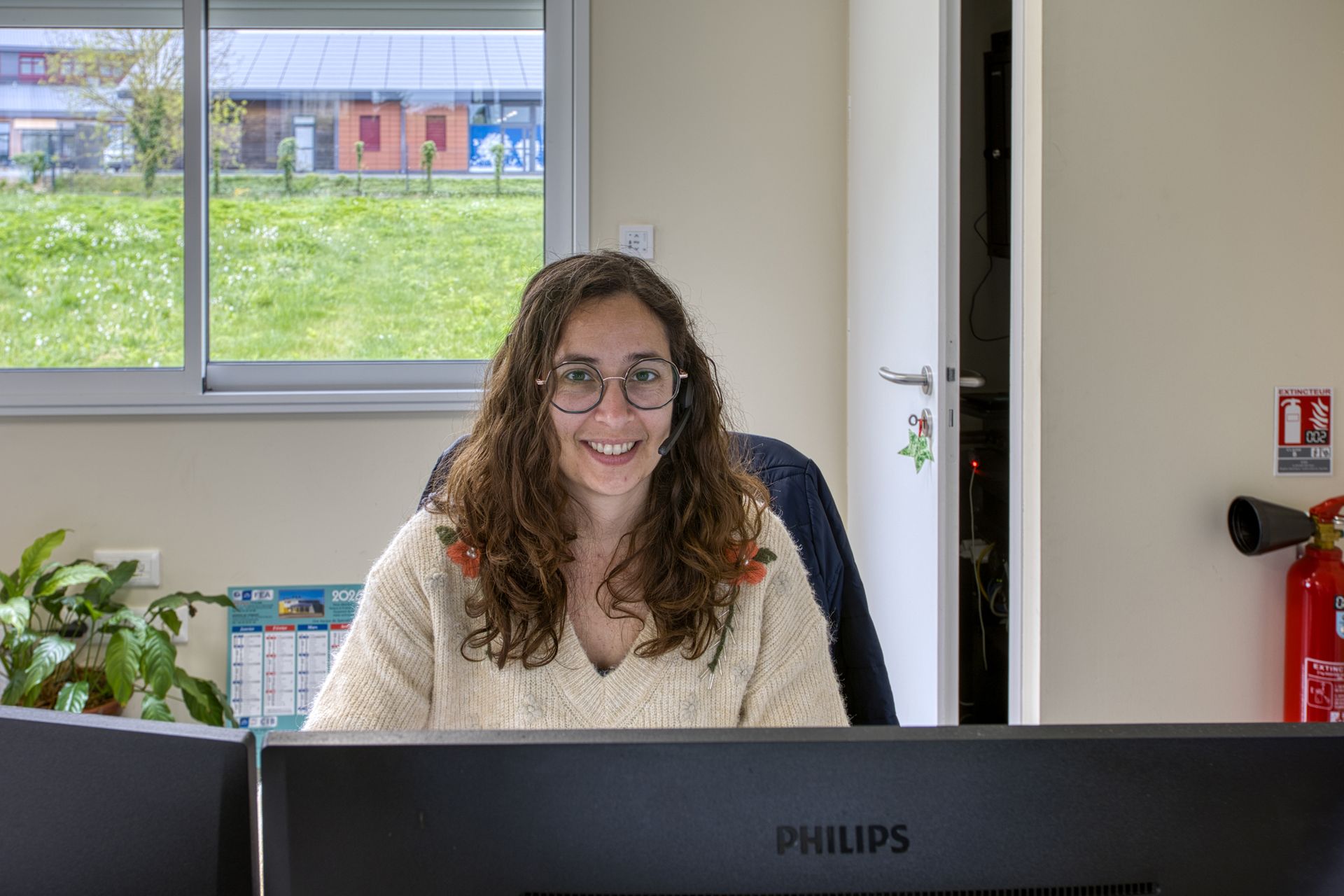 Employée souriante derrière son PC