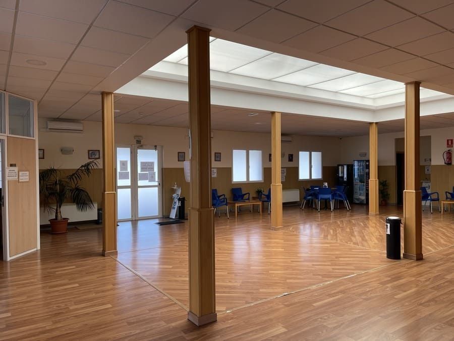 Una gran habitación con pisos y columnas de madera en un edificio.