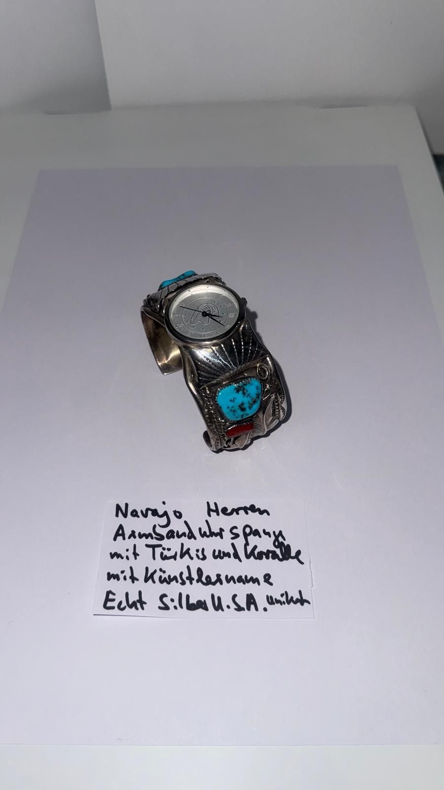 Eine Halskette aus Bernsteinperlen in verschiedenen Braun- und Orangetönen, arrangiert auf einer weißen Fläche mit einem handgeschriebenen Etikett.