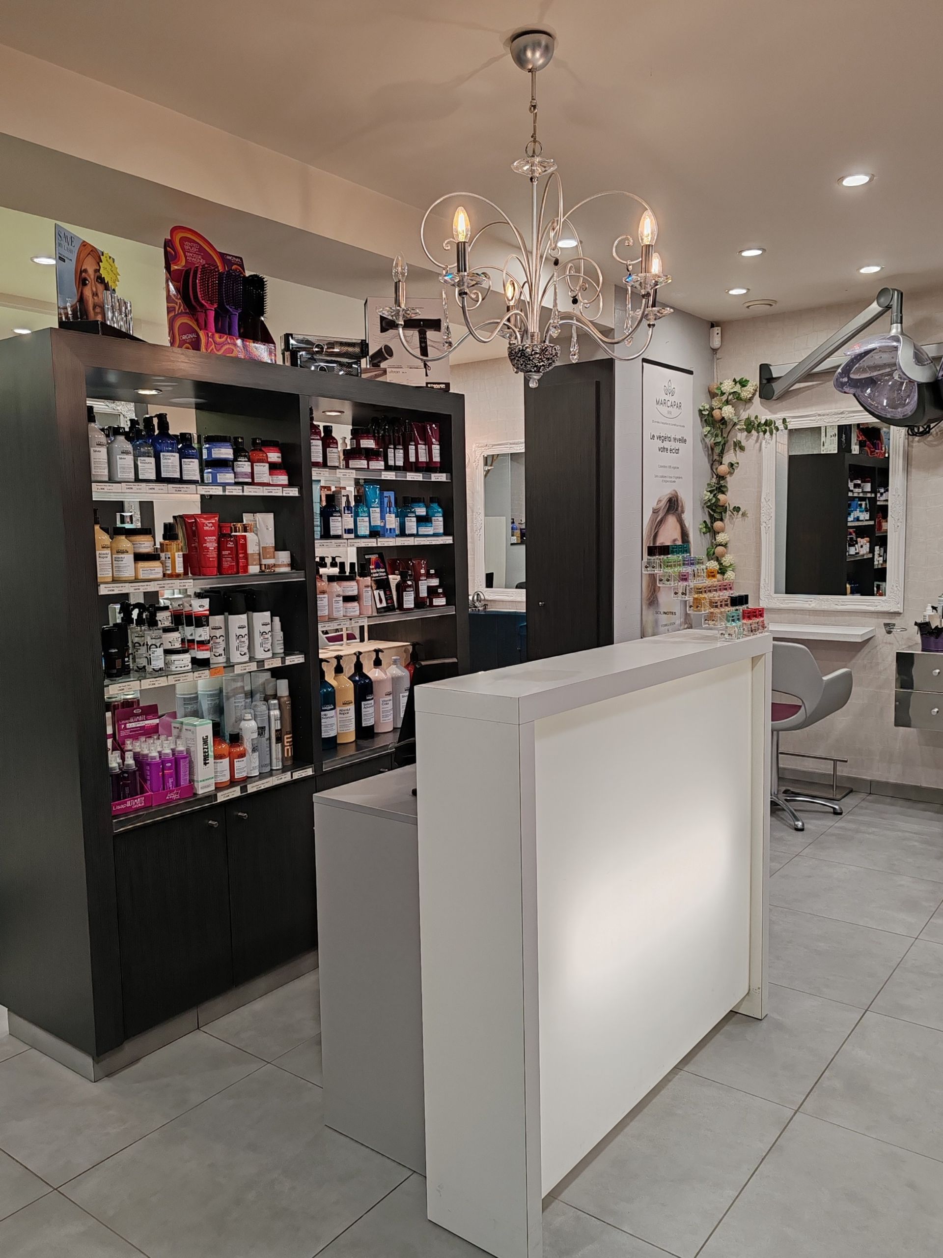 Intérieur de salon de coiffure avec un bureau de réception, un présentoir de produits.