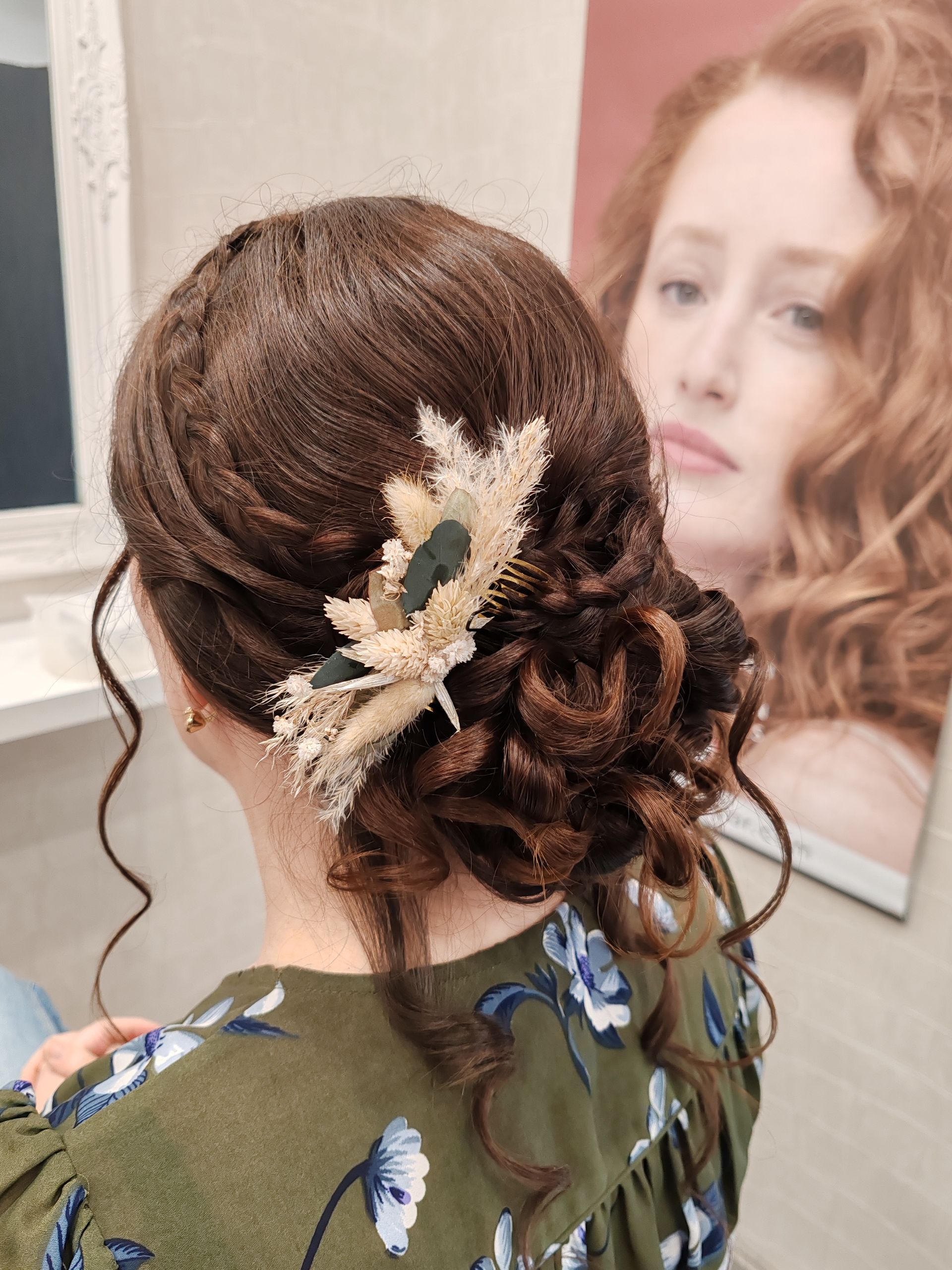 Femme aux cheveux foncés coiffés en chignon et ornés d'une pince à cheveux florale.