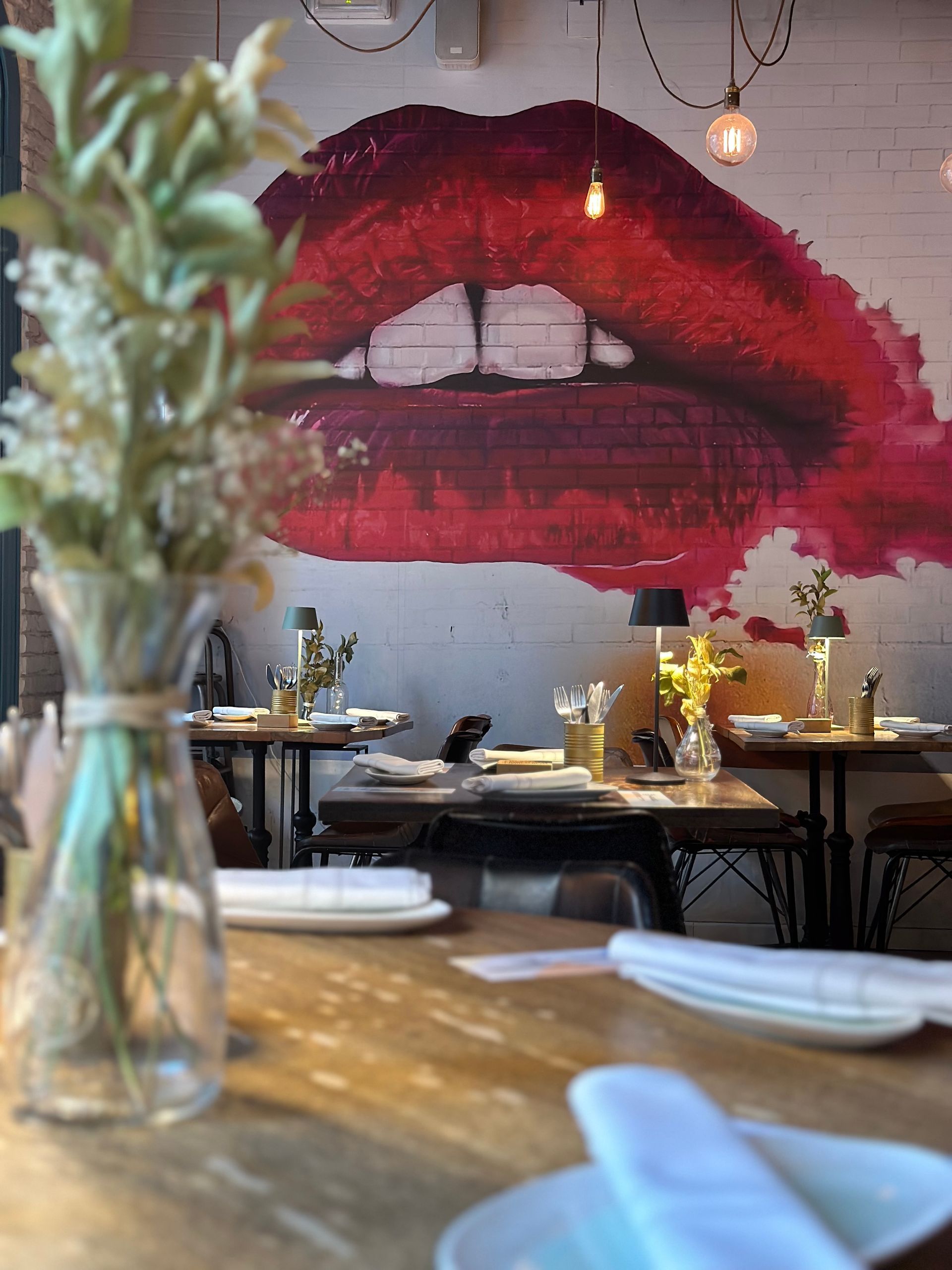 Un grupo de personas están sentadas alrededor de una mesa brindando con copas de vino.