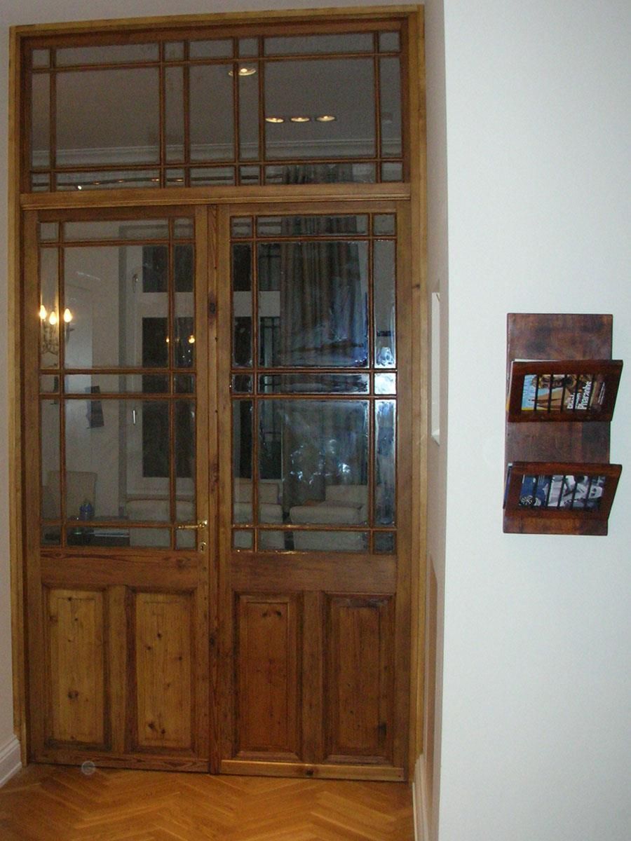 Ein Zimmer mit einer Holztür und zwei Bildern an der Wand