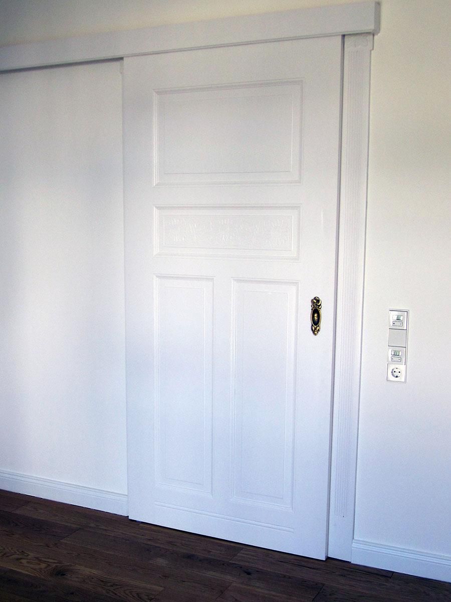 Eine weiße Schiebetür mit einem goldenen Griff