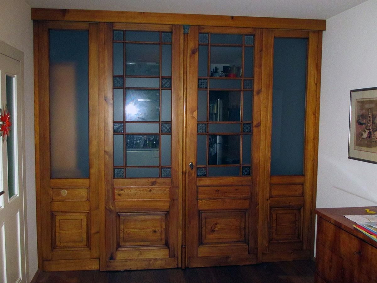 Ein Zimmer mit Holztüren und einem Bild an der Wand