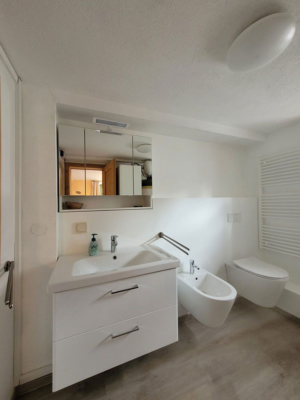 Ein Badezimmer mit Waschbecken, Toilette und Bidet