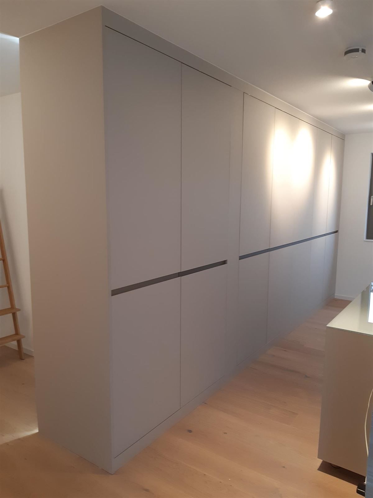 Ein Raum mit vielen Schränken und einem Holzboden