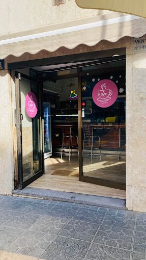 La entrada a un restaurante con un cartel rosa en la puerta.