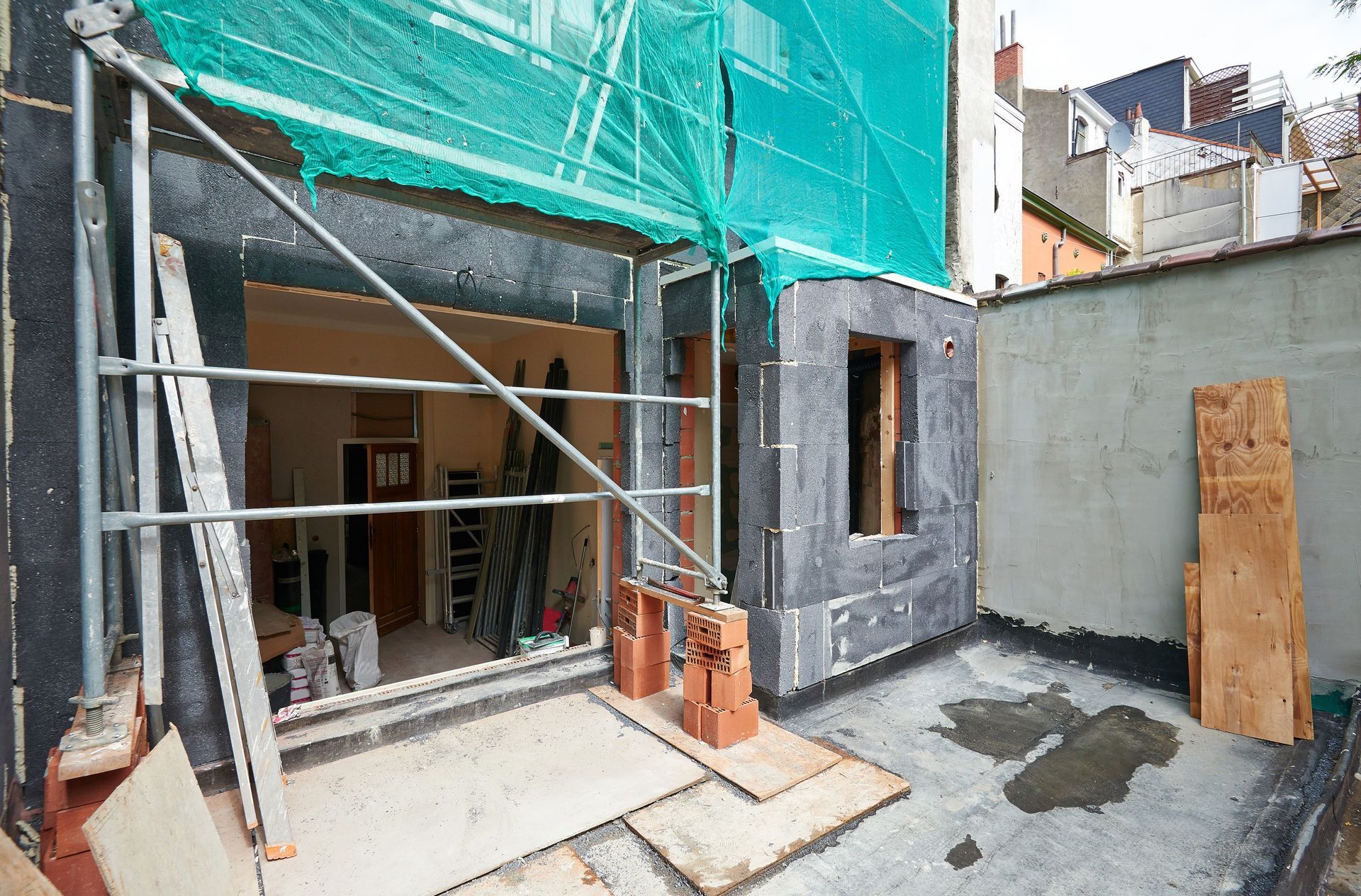 Préparation des murs et pose de panneaux isolants sur une façade.