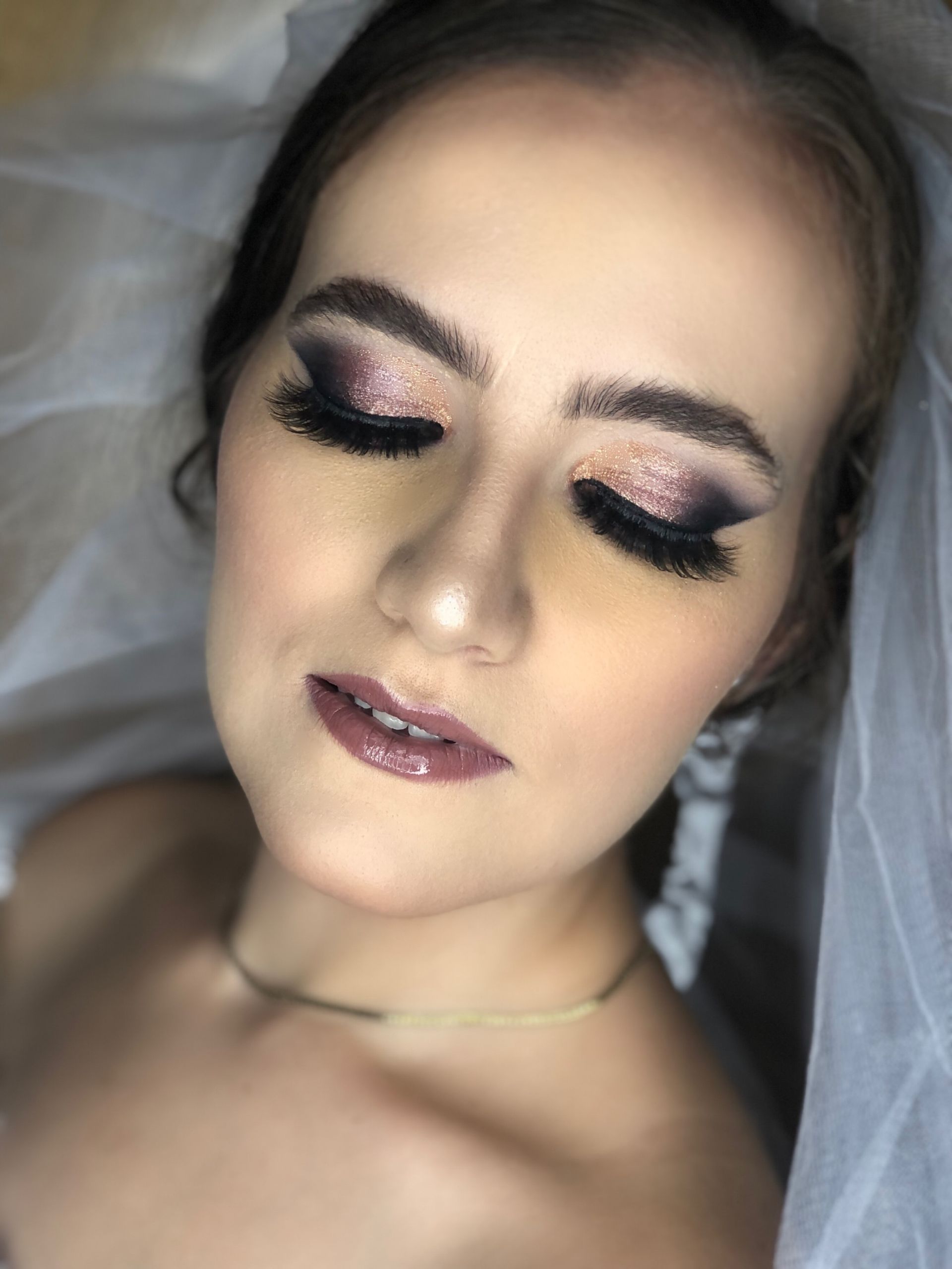 Un primer plano del rostro de una mujer con maquillaje y velo.
