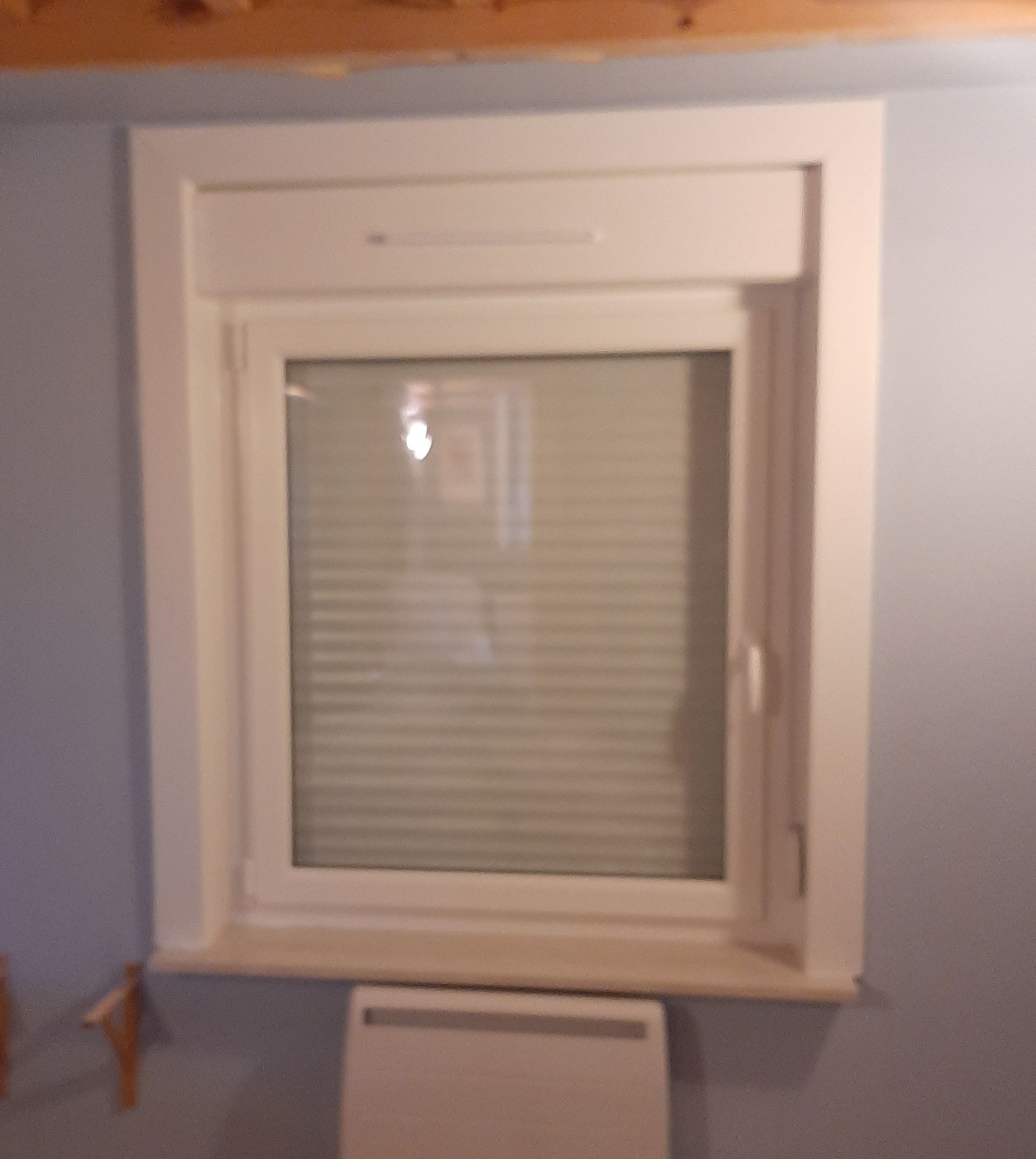 Fenêtre PVC blanche avec volet roulant, vue intérieure