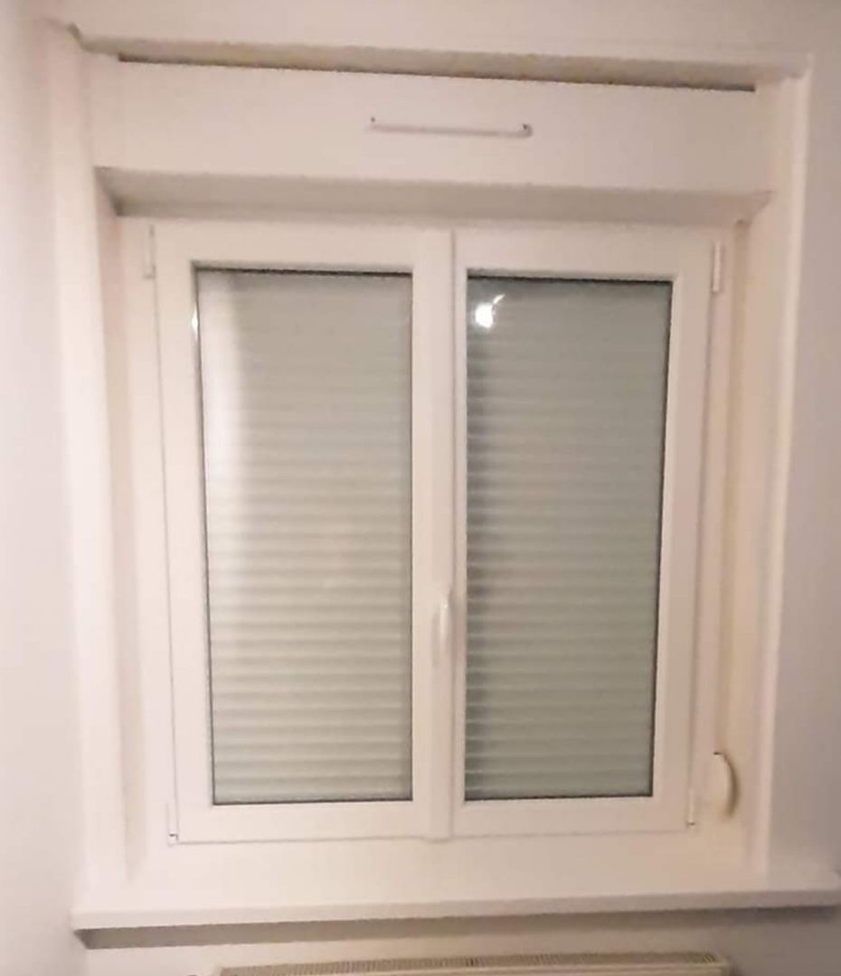 Fenêtre PVC blanc deux battants avec volet roulant fermé