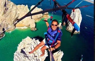 Parasailing over the blue waters of Cabo San Lucas Bay