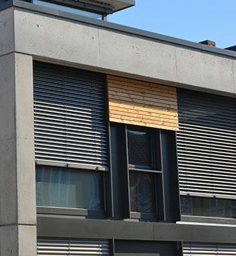 Ein Gebäude mit vielen Fenstern und Jalousien