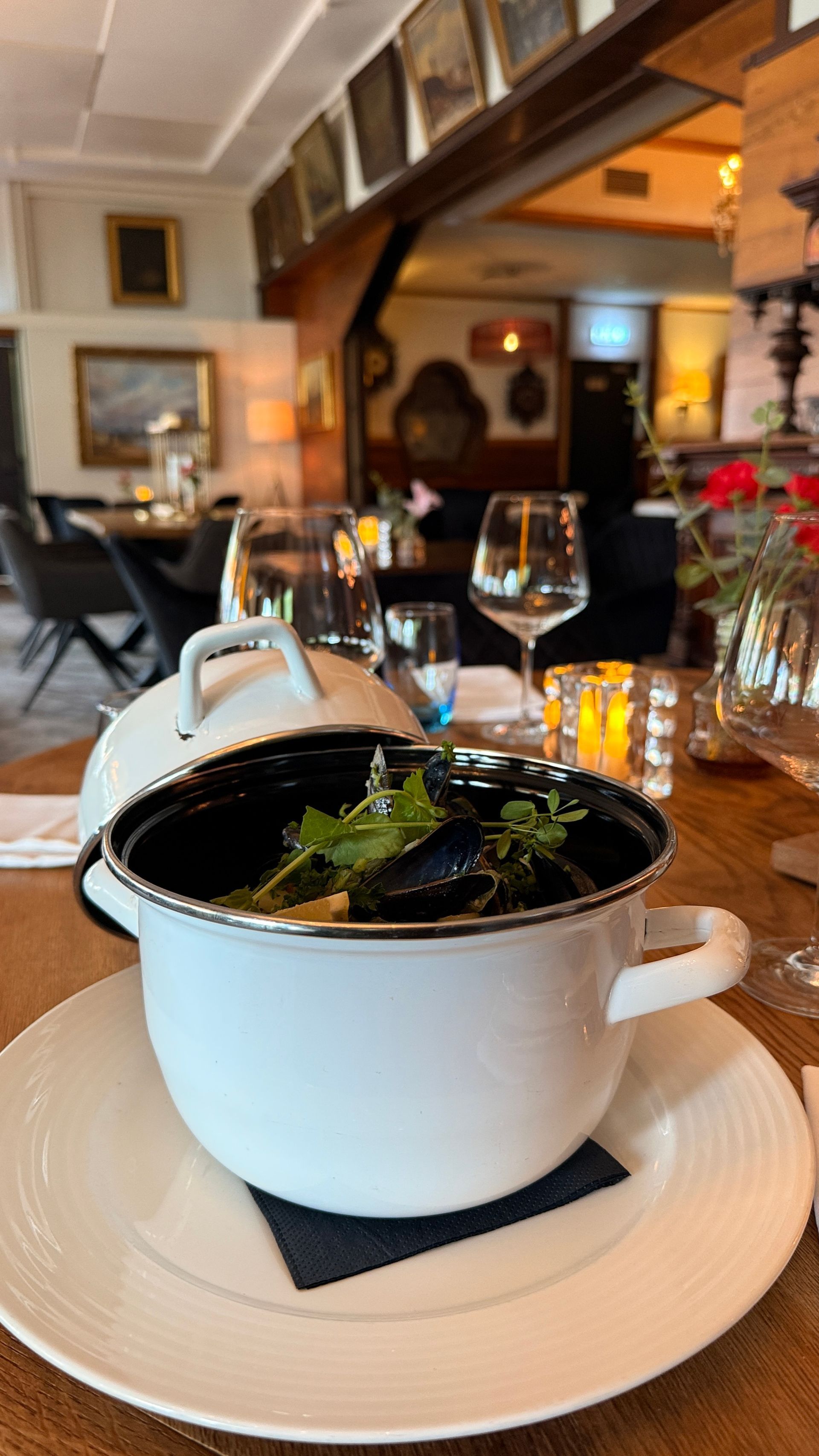 Een serveerster draagt ​​twee borden met eten in een restaurant.
