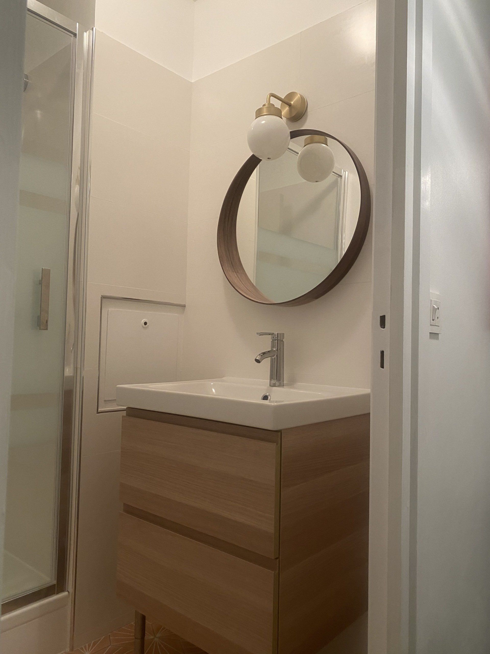 Aménagement de salle de bains vue du miroir et de l'évier