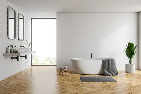 Un baño con bañera, lavabo y ventana.