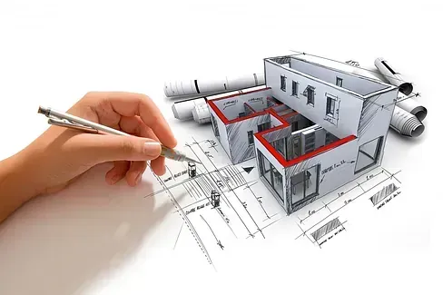 Una persona está dibujando una casa en un plano con un bolígrafo.
