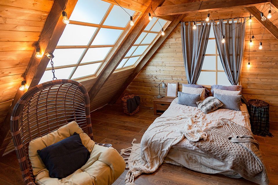 A bedroom with a bed , chair , and window.