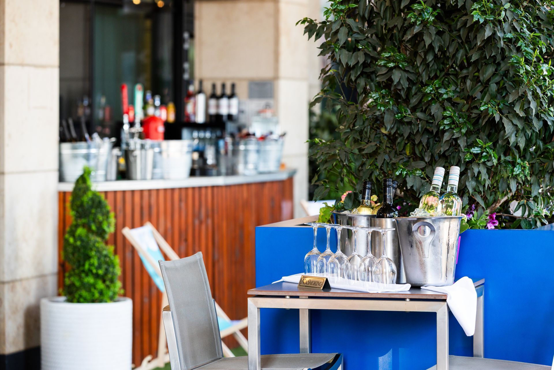 outside restaurant with bottlecoolers and drinks, a bar in the background