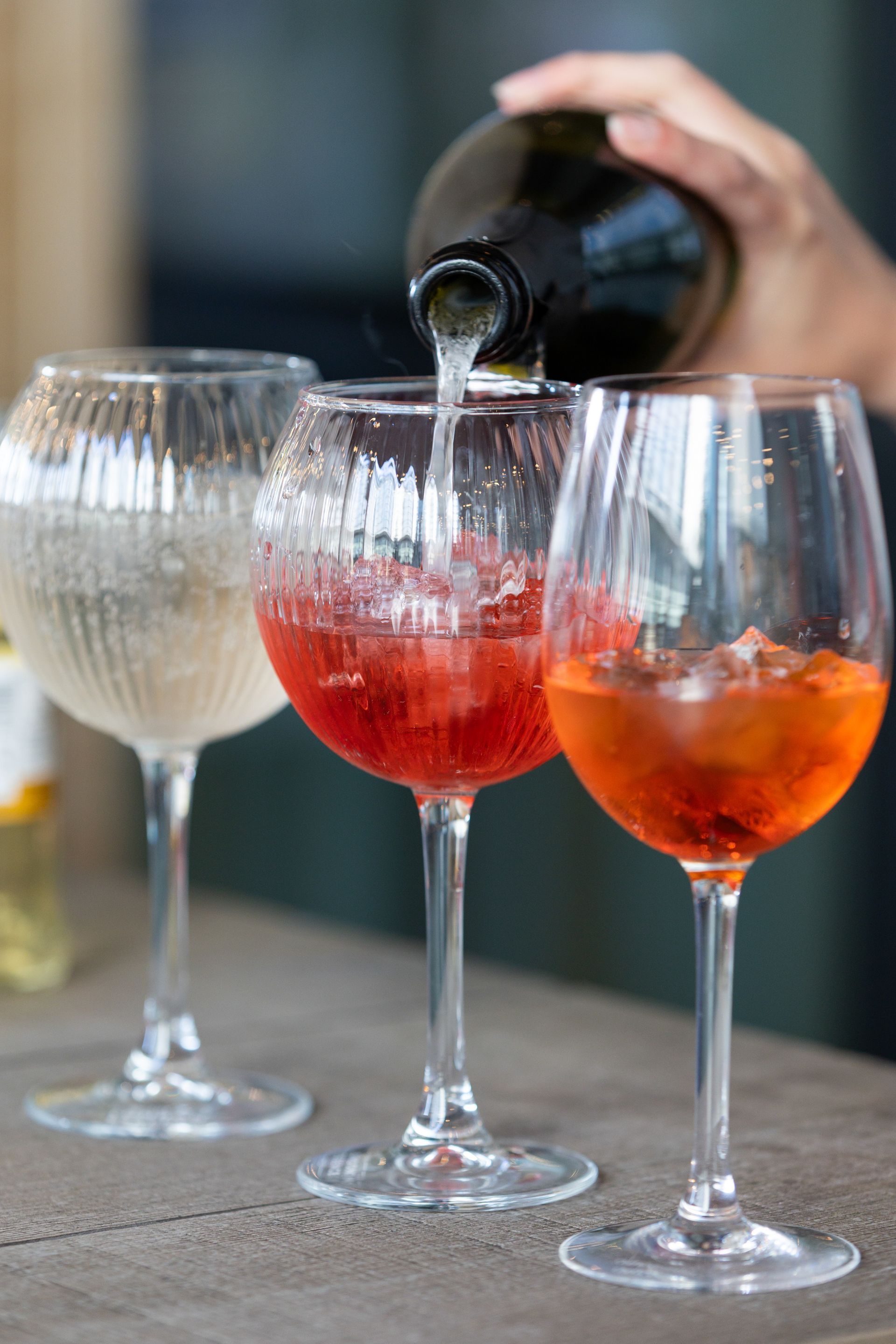 three glasses with different aperetives or cocktails