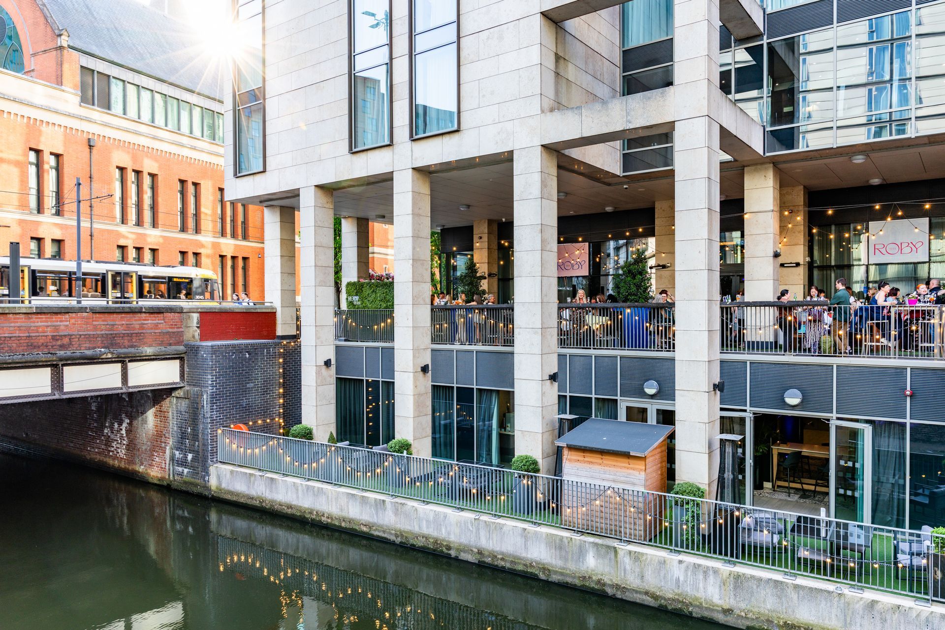 view from over the canal to the terrace outsite department of the restaurant