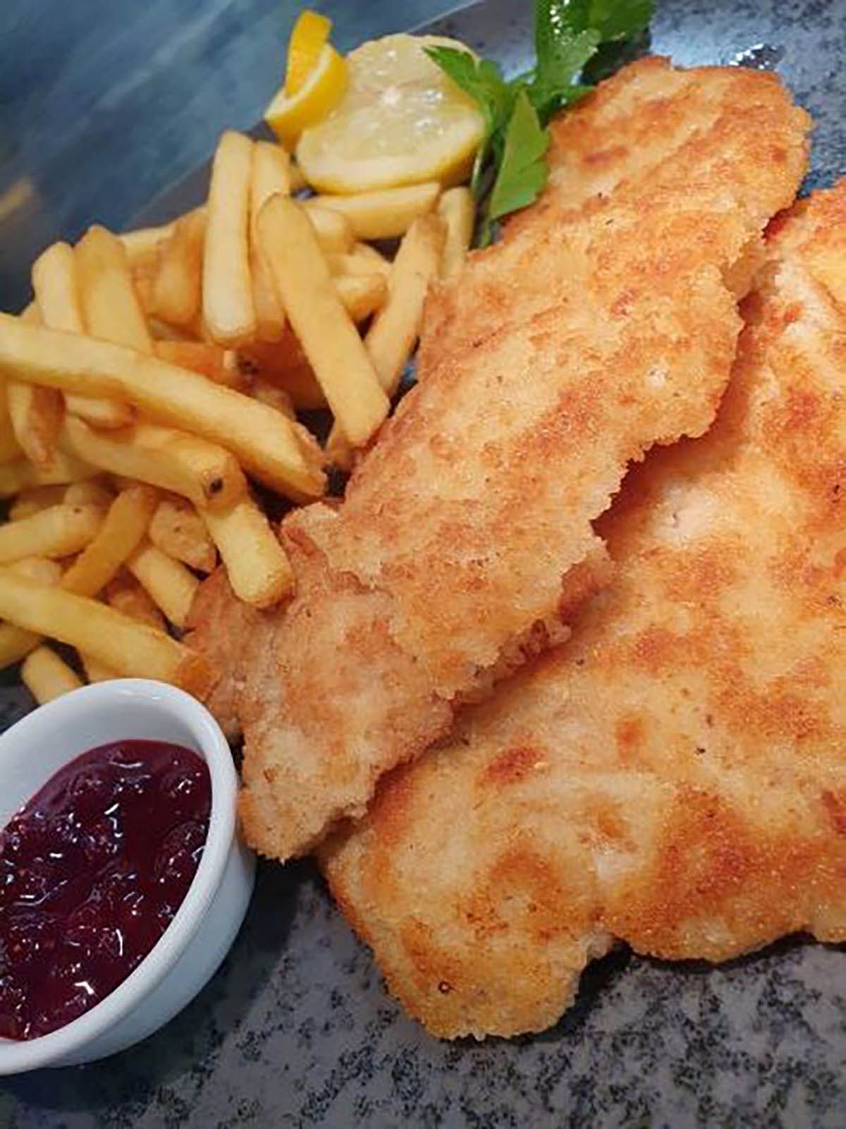 Wienerschnitzel mit Pommes und Preiselbeeren