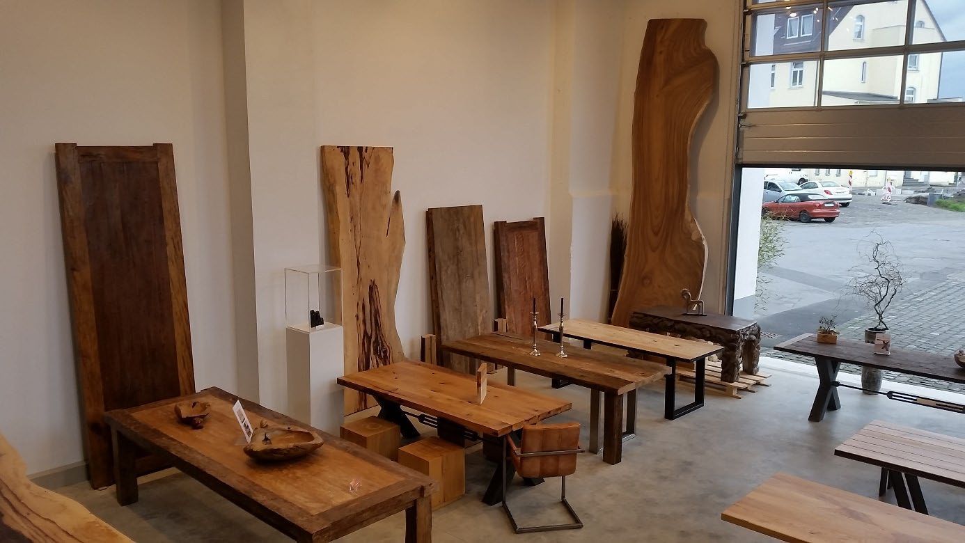 Werkraum mit Holzplatten, Tischen und natürlichem Lichteinfall.