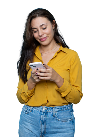 Une femme avec une chemise jaune moutarde tenant son smartphone.