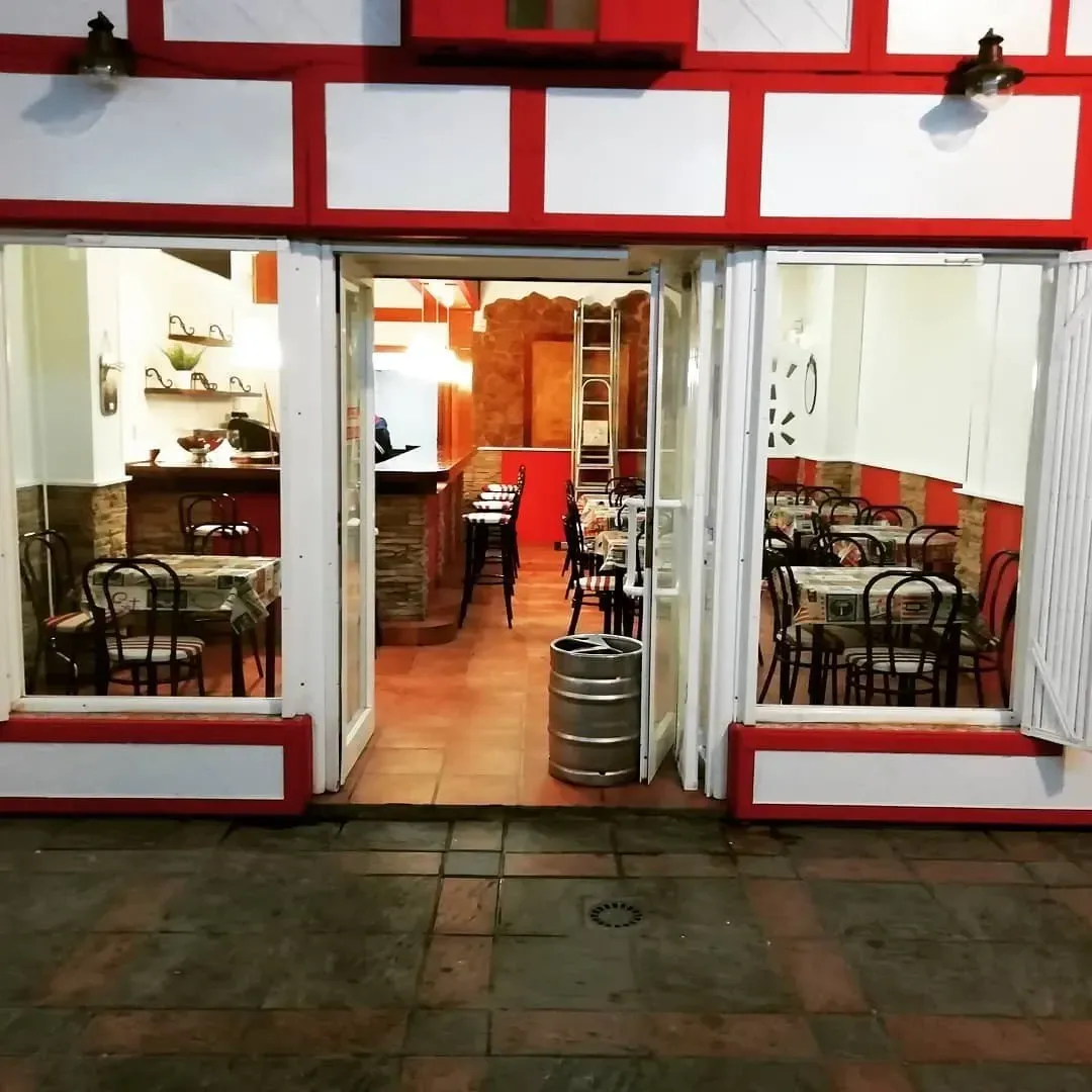 El interior de un restaurante con mesas y sillas.
