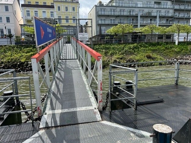 Eine Brücke über ein Gewässer mit Gebäuden im Hintergrund.