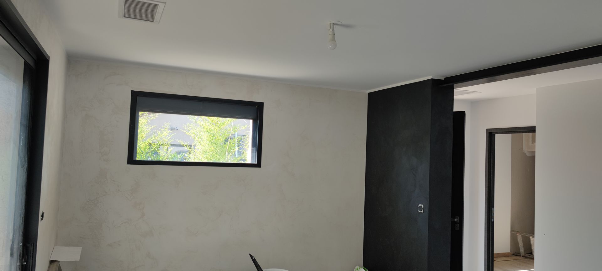 Pièce spacieuse noir et blanc avec une grande ouverture de la pièce.