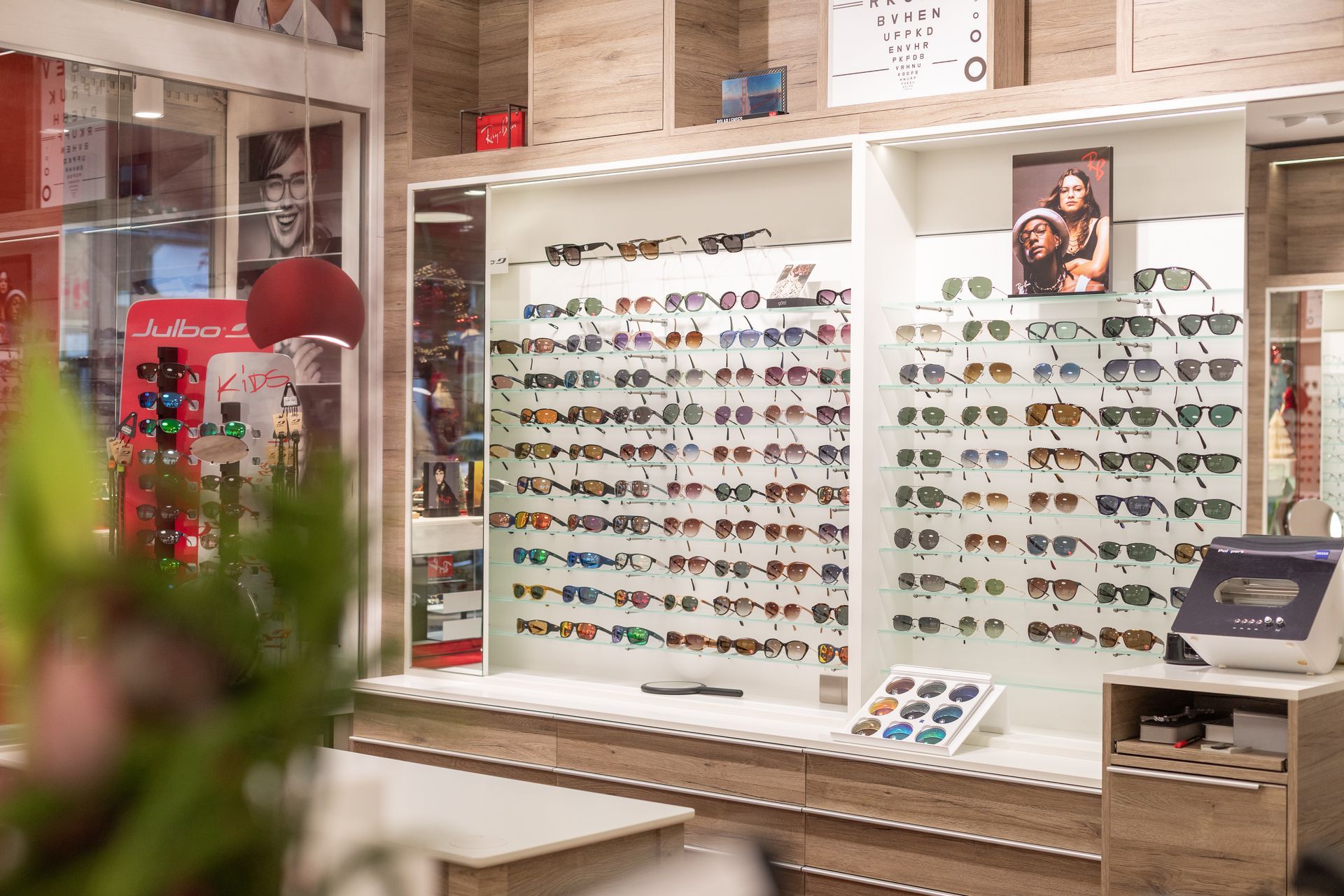 Sonnenbrillen in einem Verkaufsständer; verschiedene Stile, Farben und Designs sind zu sehen.