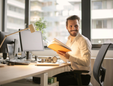 Two men are looking at a laptop computer.