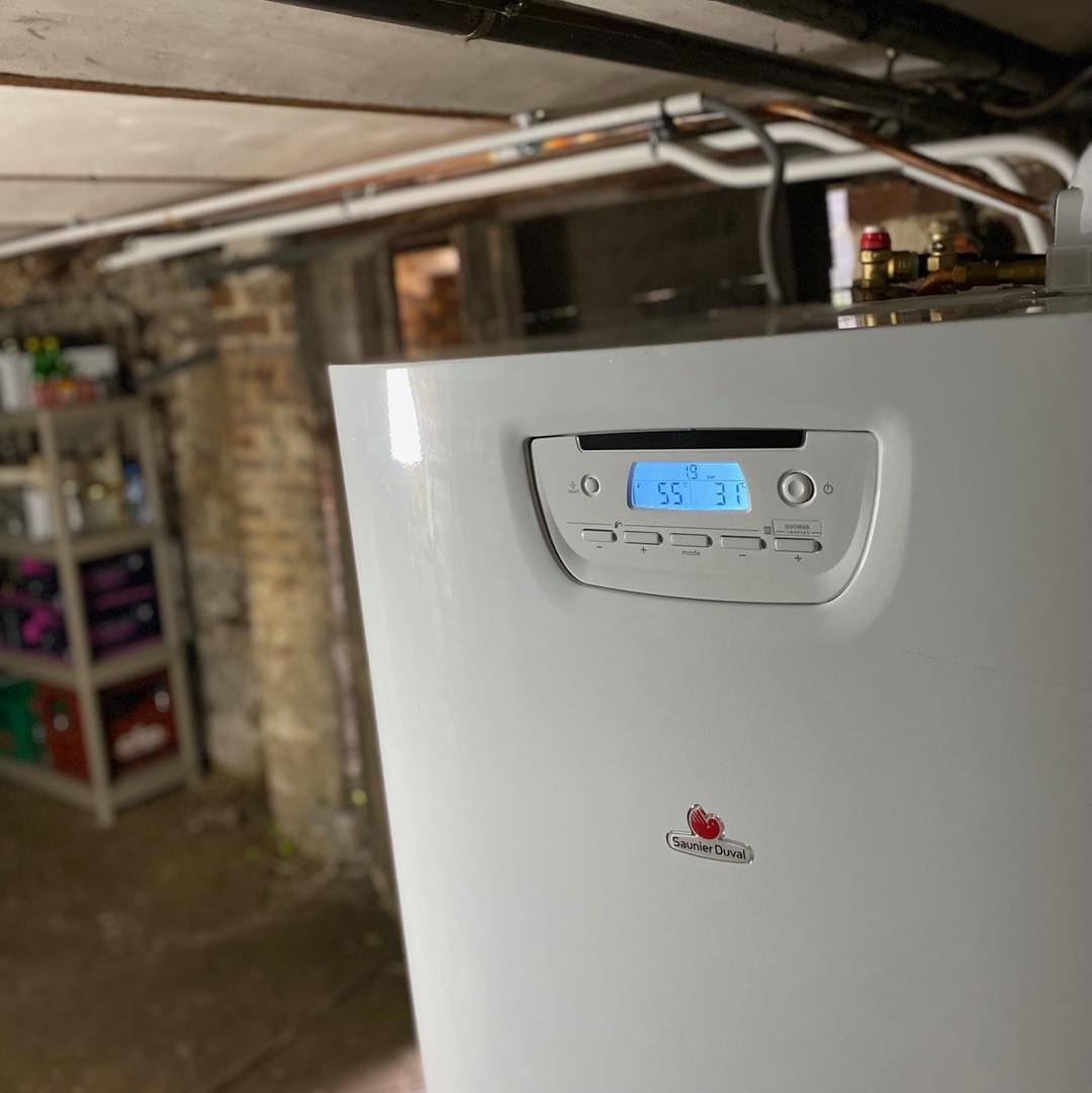 Chaudière dans un espace avec mur en briques et affichage de la température