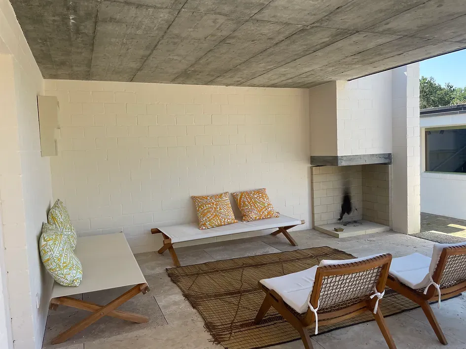 Ein Wohnzimmer mit Sofa, Stühlen und Kamin.