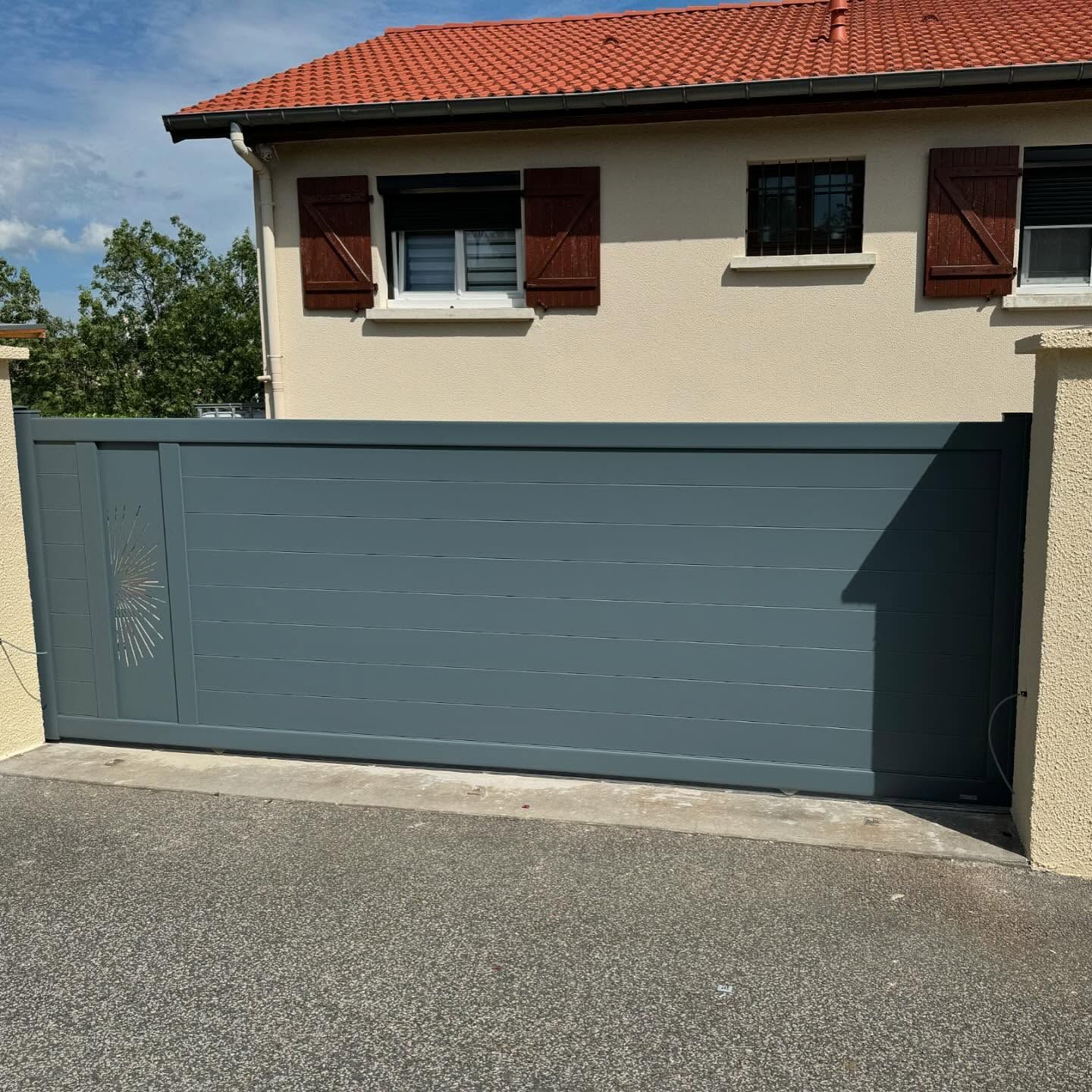 Portail coulissant fermé d'une habitation.