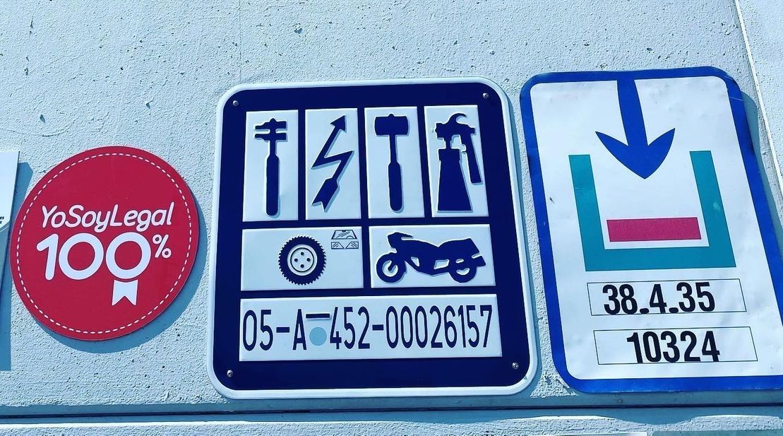 Tres carteles en una pared, uno de los cuales dice 