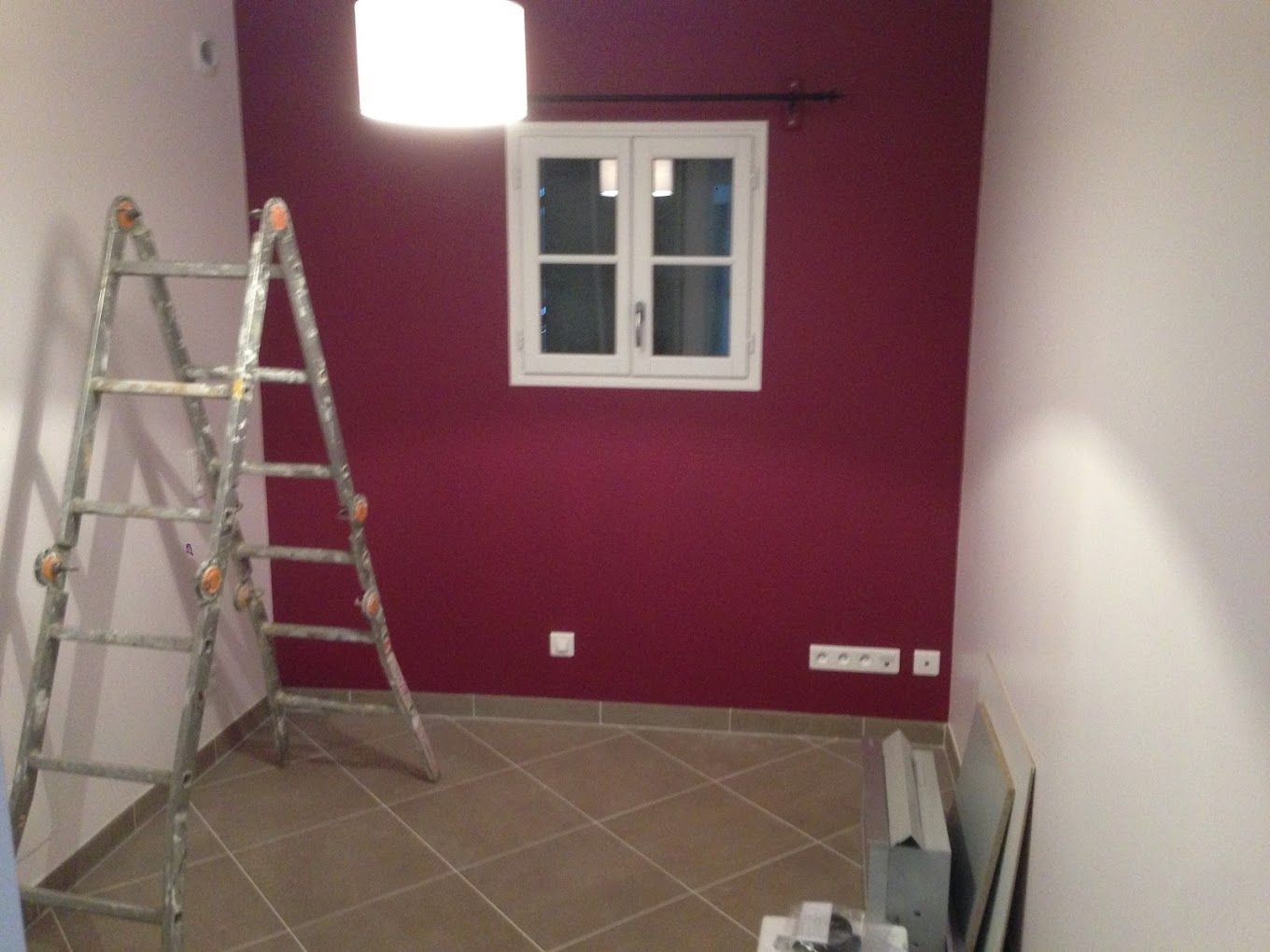 Intérieur de pièce de maison, mur peint en rouge et carrelage clair