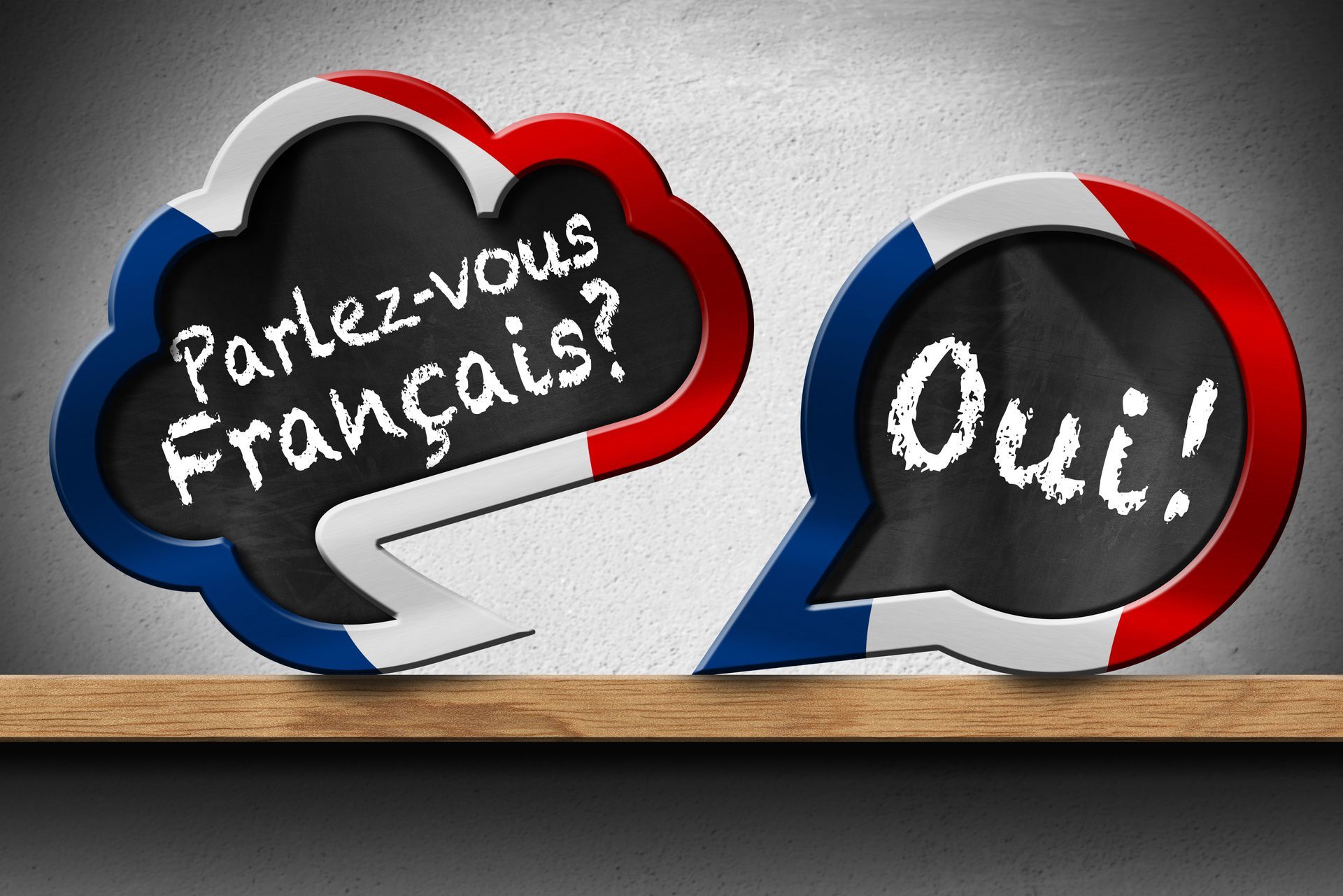 Zwei Sprechblasen mit den Worten „Sprichst du Französisch?“ und „Ja“