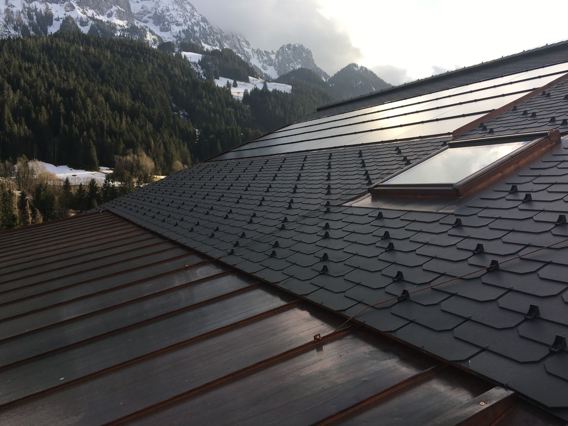 A man is working on a roof with a drill.