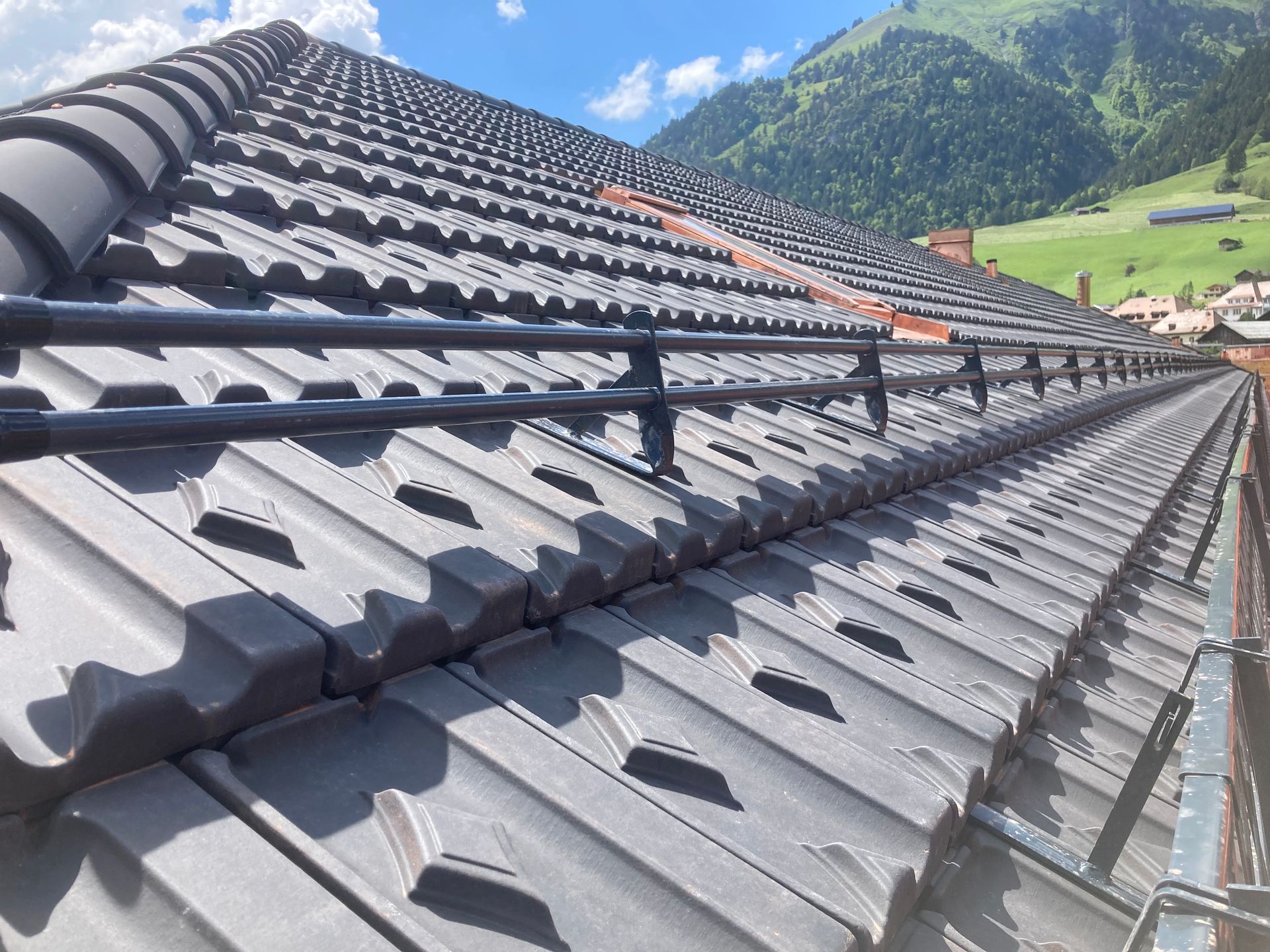 A man is working on a roof with a pair of pliers.