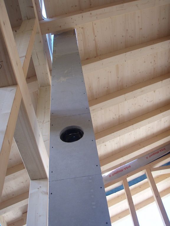 A plumber is working on a pipe system.