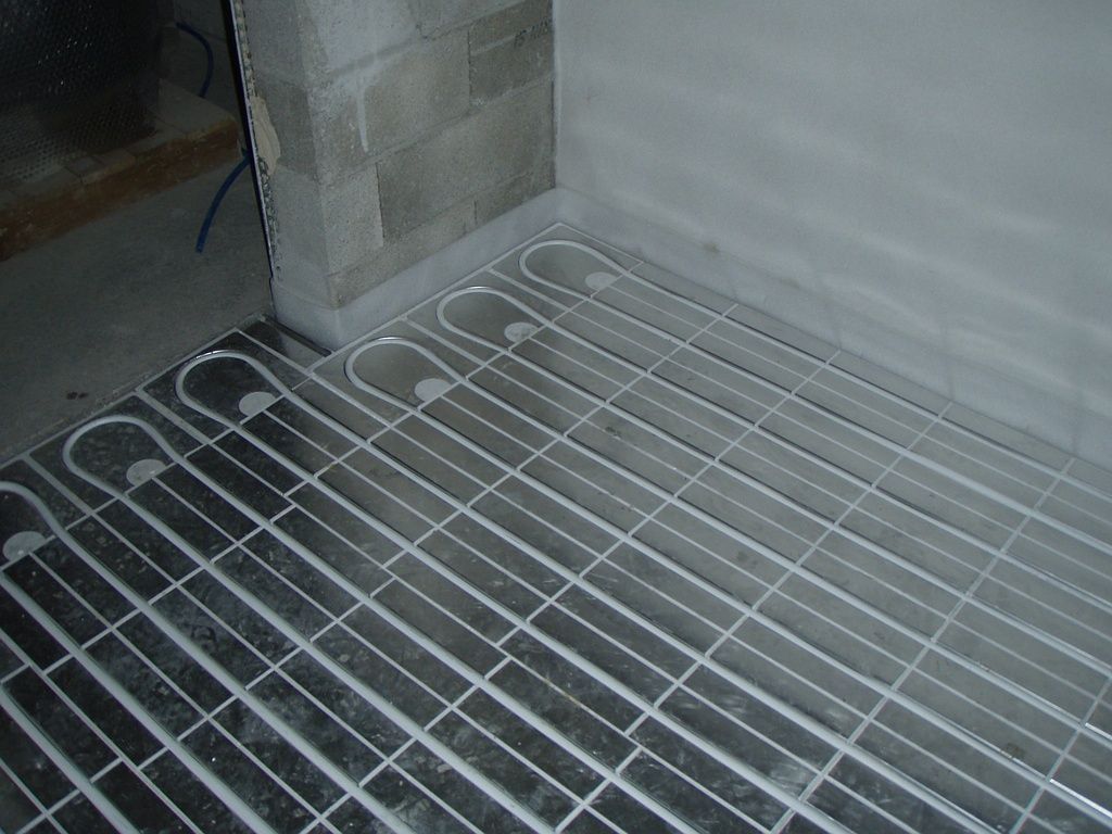 A plumber is working on a pipe system.