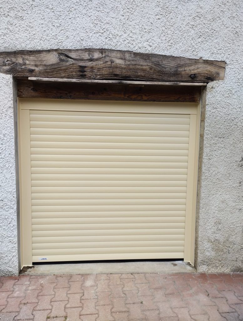 Une porte de garage enroulable couleur beige.
