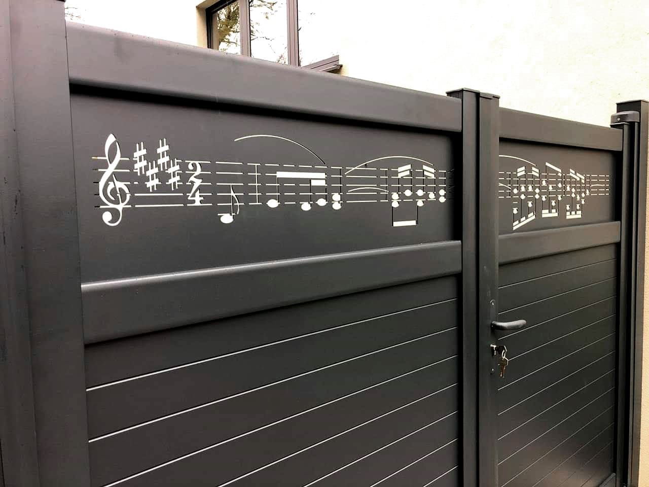 Fresque patition de musique sur un portail.