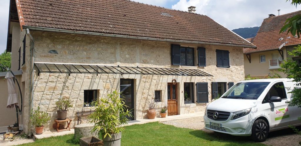 Une grande marquise le long d'une terasse d'une grande habitation.