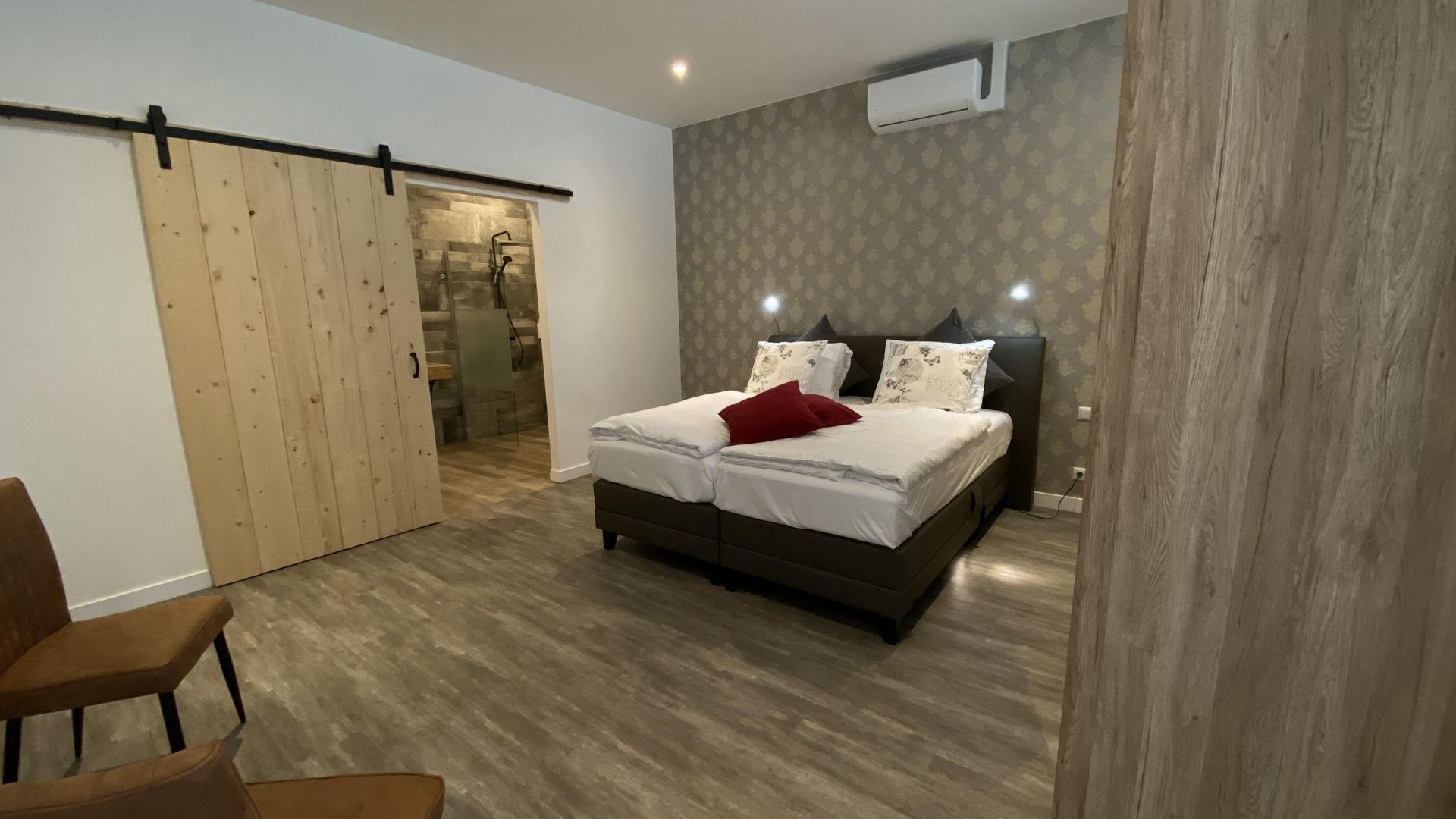 Een slaapkamer met twee bedden en een schuifdeur.