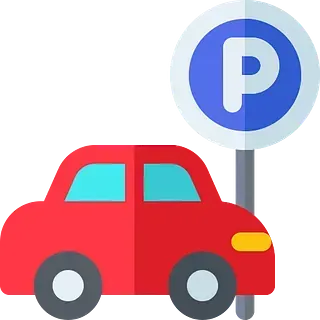 Un coche rojo está aparcado al lado de una señal de aparcamiento.